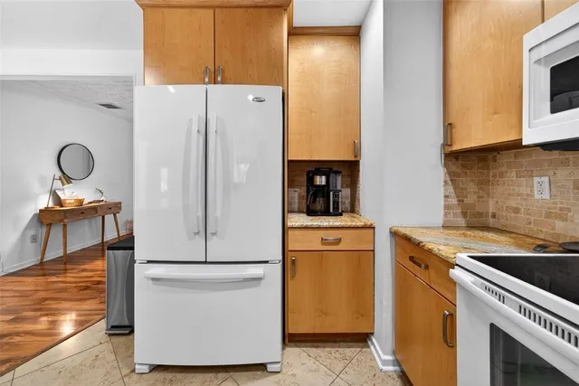 a spacious bedroom with two beds and painting on the wall