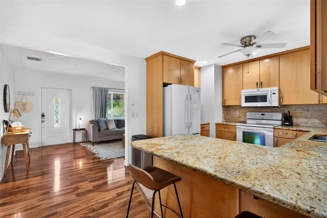 a bedroom with a bed a table and chair