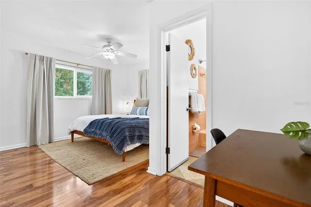 a bedroom with a bed and wooden floor