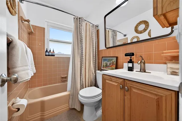 a dining room with furniture and a large window