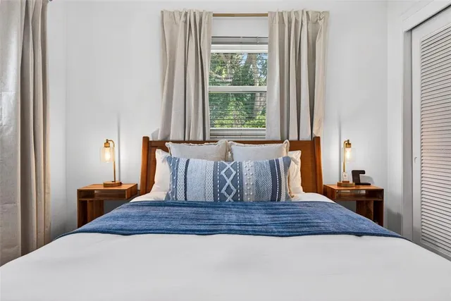 a dining room with furniture and a floor to ceiling window