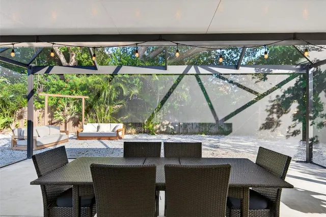 a view of backyard with outdoor seating and trees