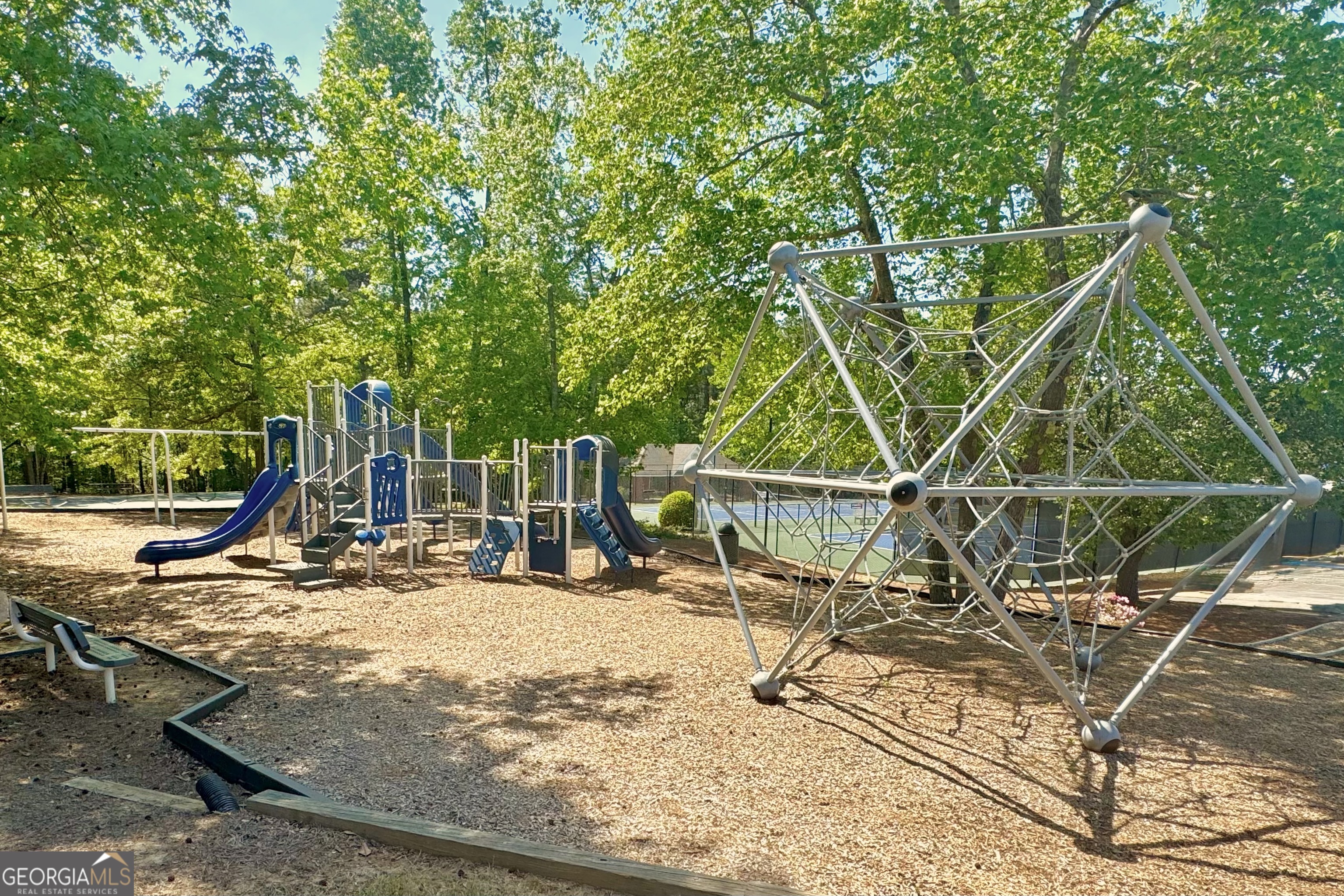 144 Constitution Pointe Dallas, GA 30132 - Photo 12 of 12 a view of a backyard with a slide and trees