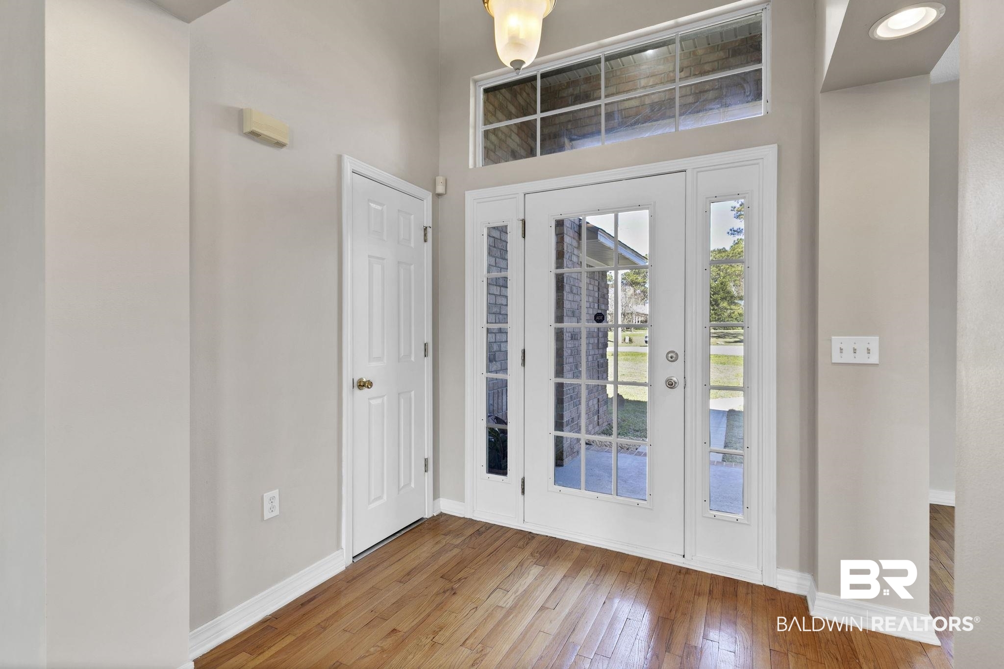 10238 Grove Drive Fairhope, AL 36532 - Photo 6 of 39 Entryway featuring light wood-style flooring and baseboards