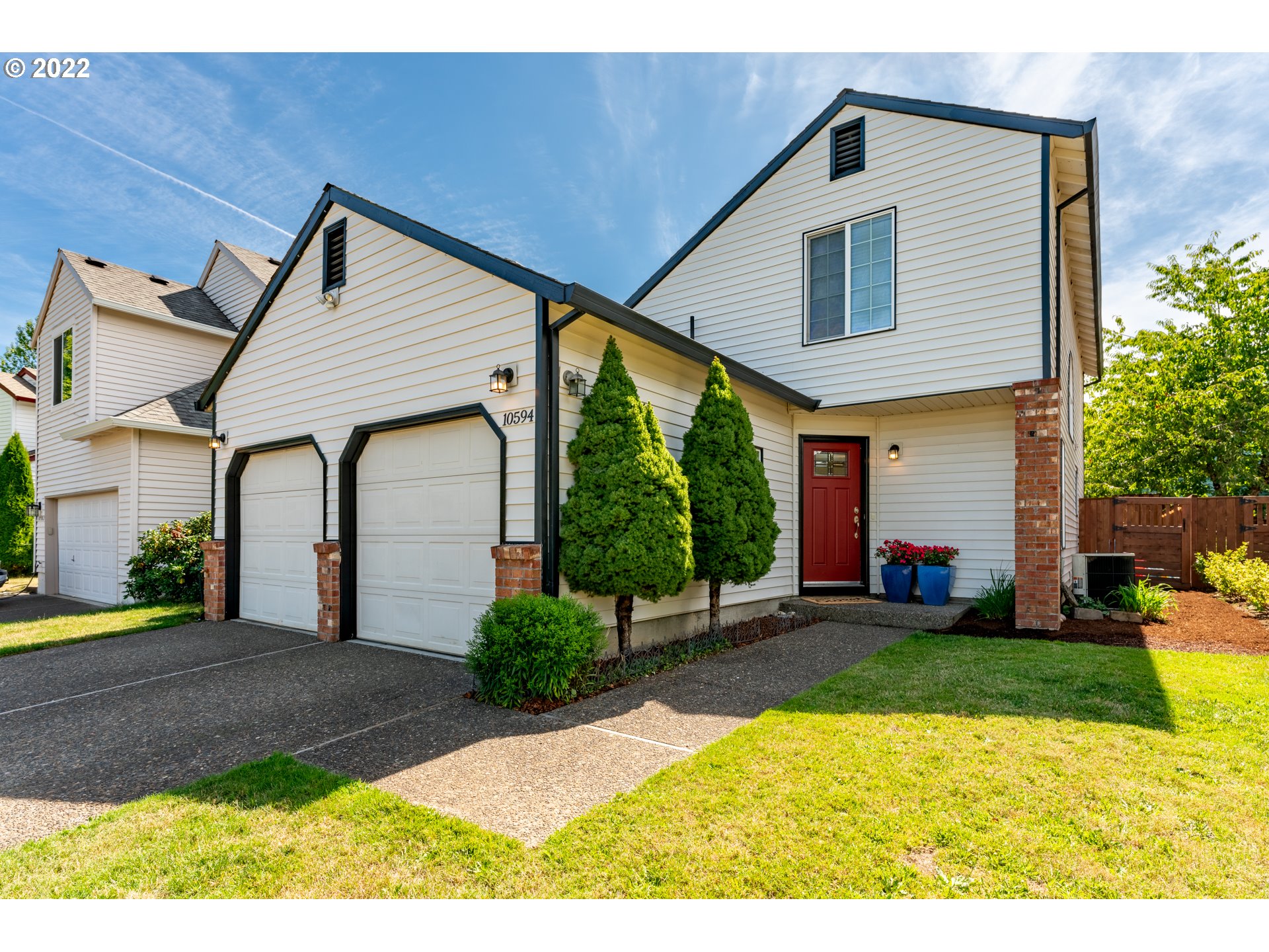 10594 Southwest Windsor Court Tigard, OR 97223 - Photo 1 of 31 a front view of a house with a yard and trees