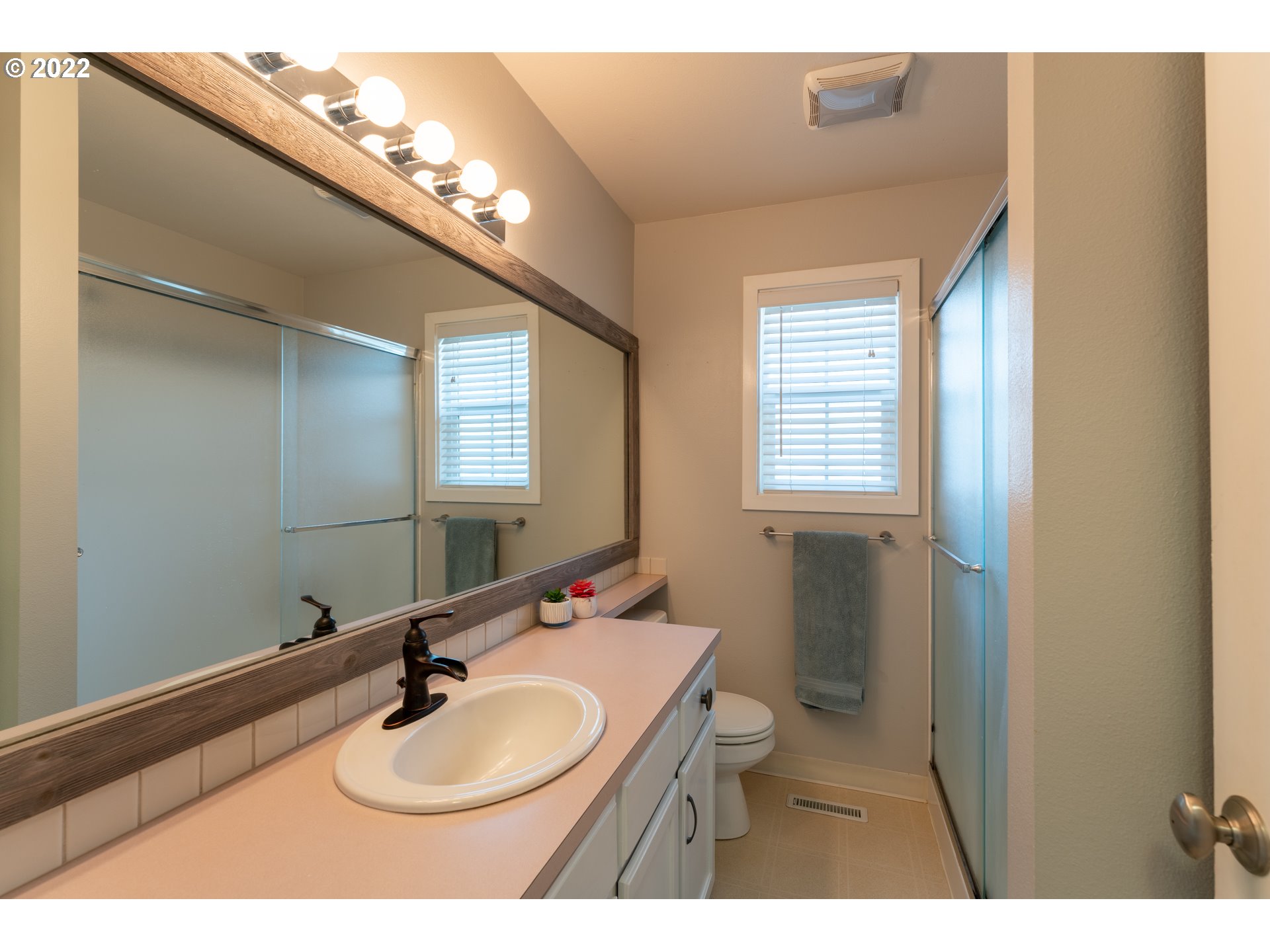 10594 Southwest Windsor Court Tigard, OR 97223 - Photo 12 of 31 a bathroom with a sink vanity mirror and toilet