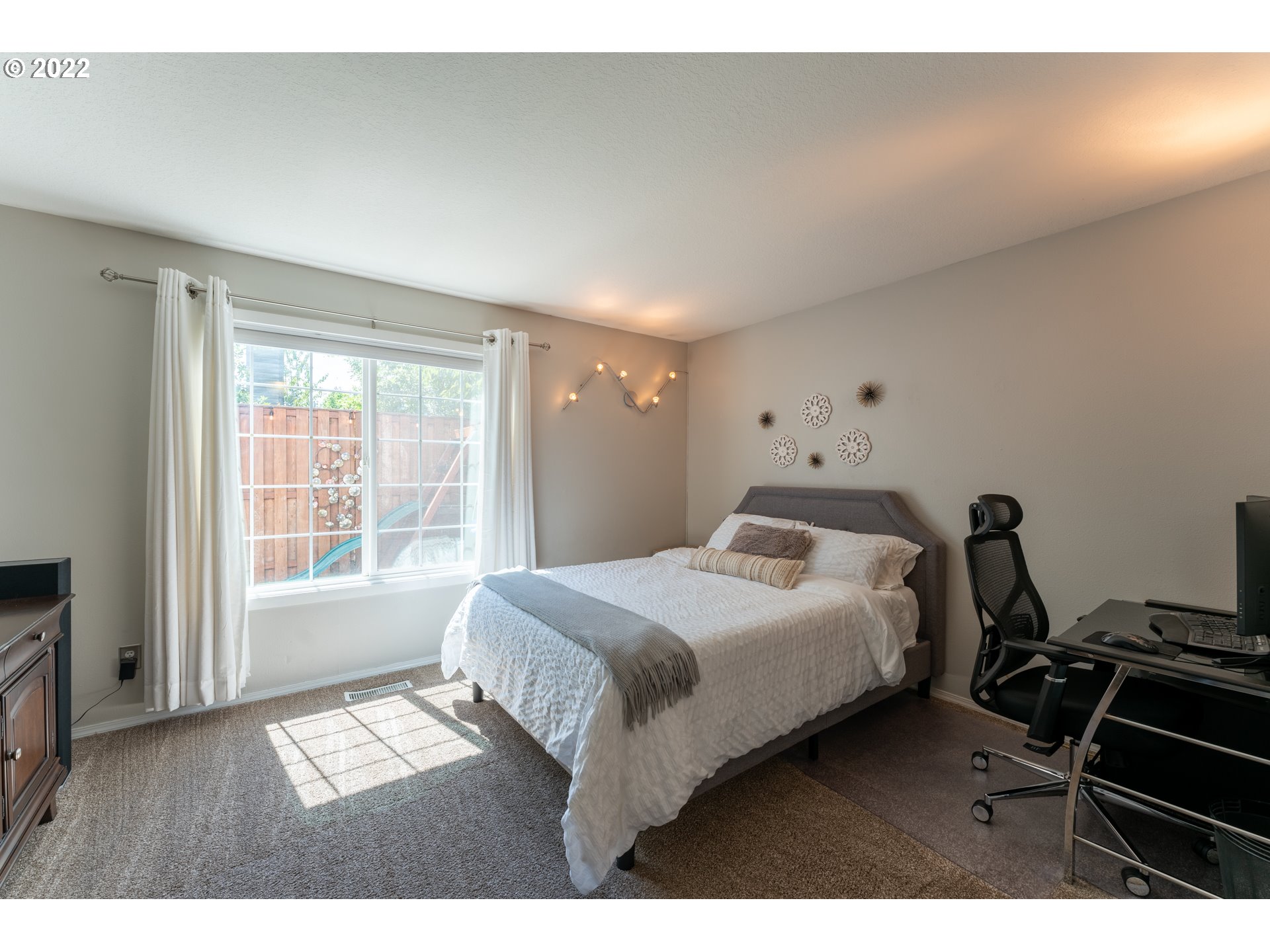 10594 Southwest Windsor Court Tigard, OR 97223 - Photo 13 of 31 a bedroom with a bed and a large window