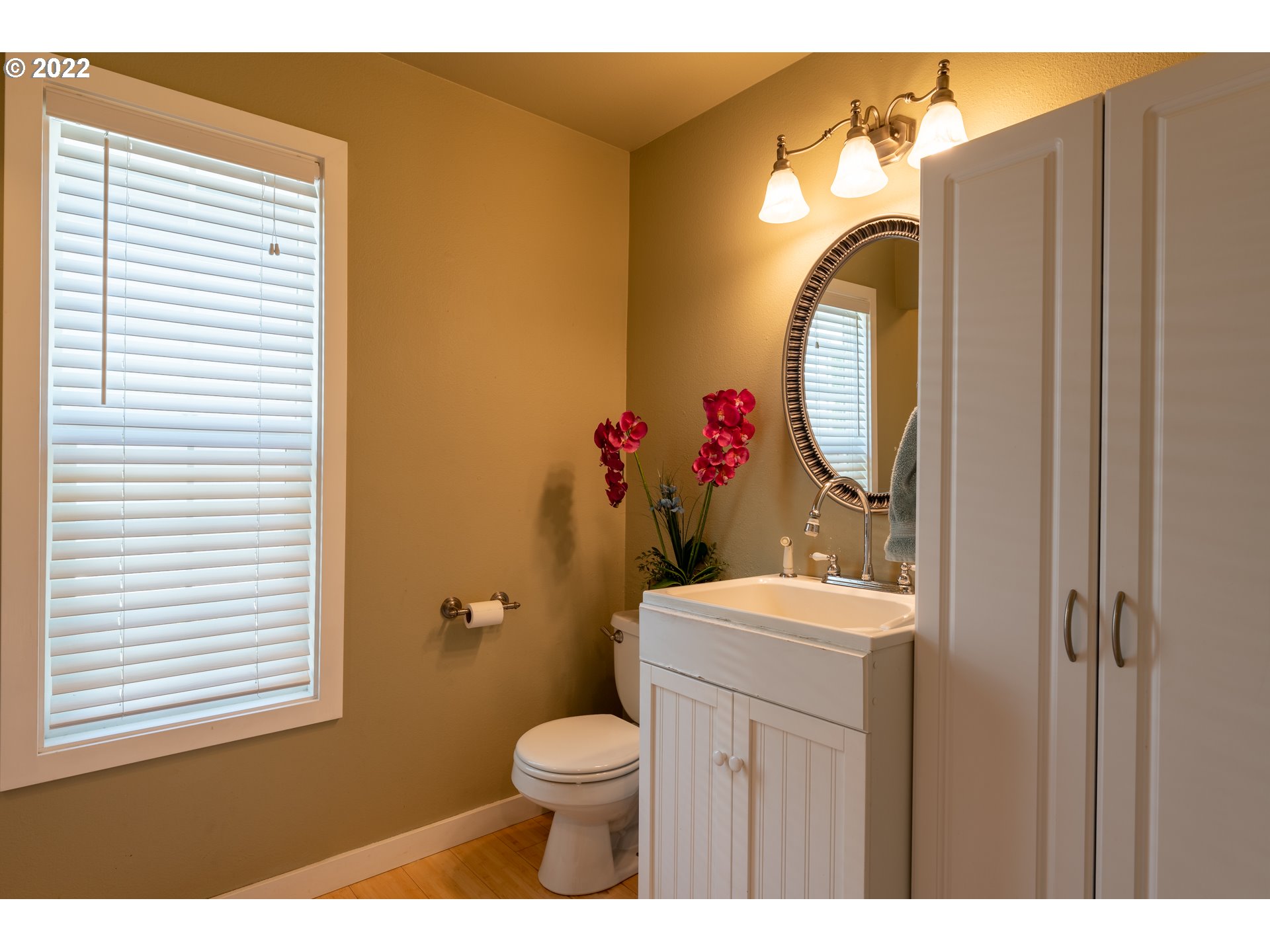 10594 Southwest Windsor Court Tigard, OR 97223 - Photo 15 of 31 a bathroom with a toilet a sink and a mirror