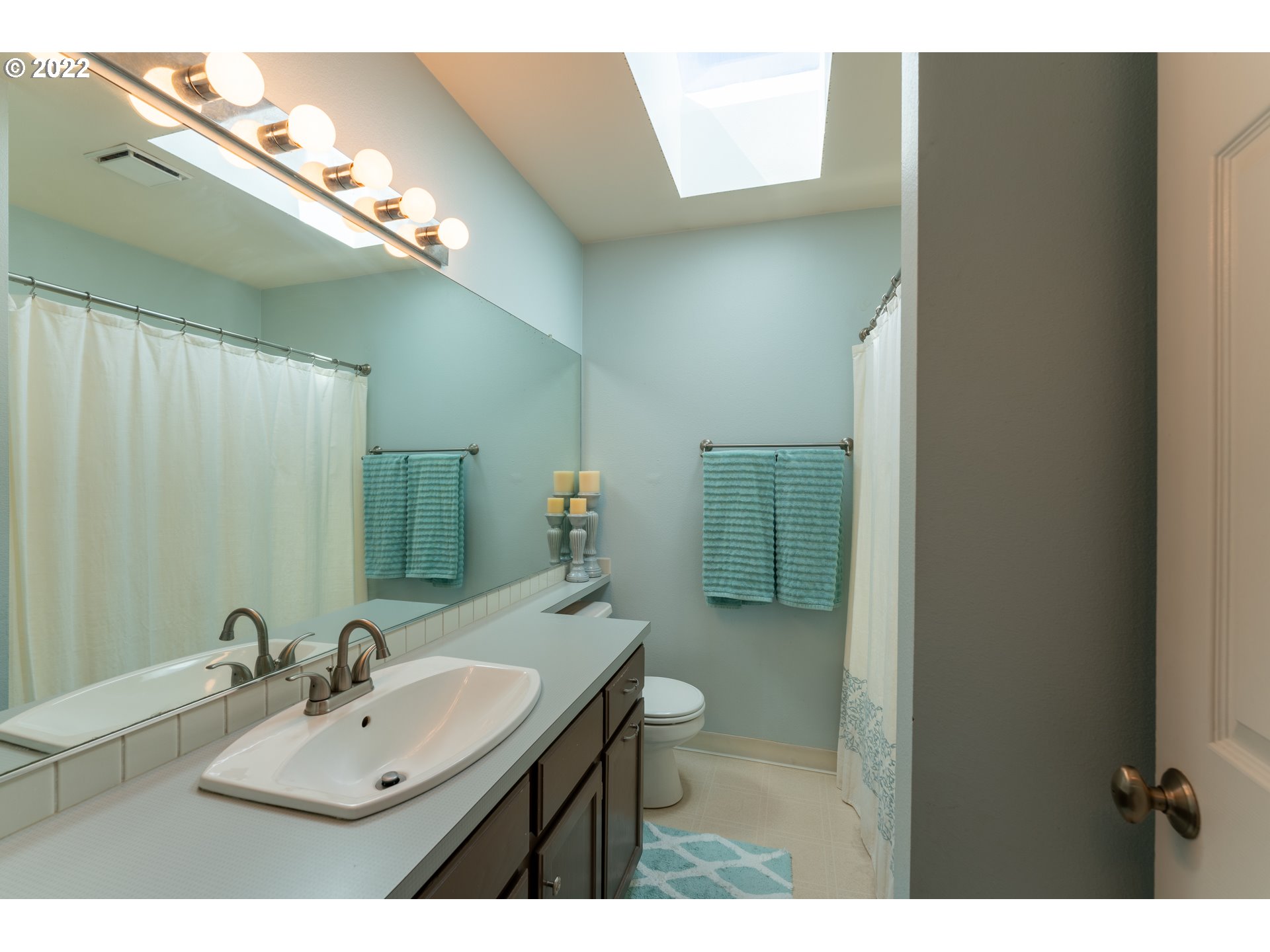 10594 Southwest Windsor Court Tigard, OR 97223 - Photo 19 of 31 a bathroom with a sink mirror and toilet