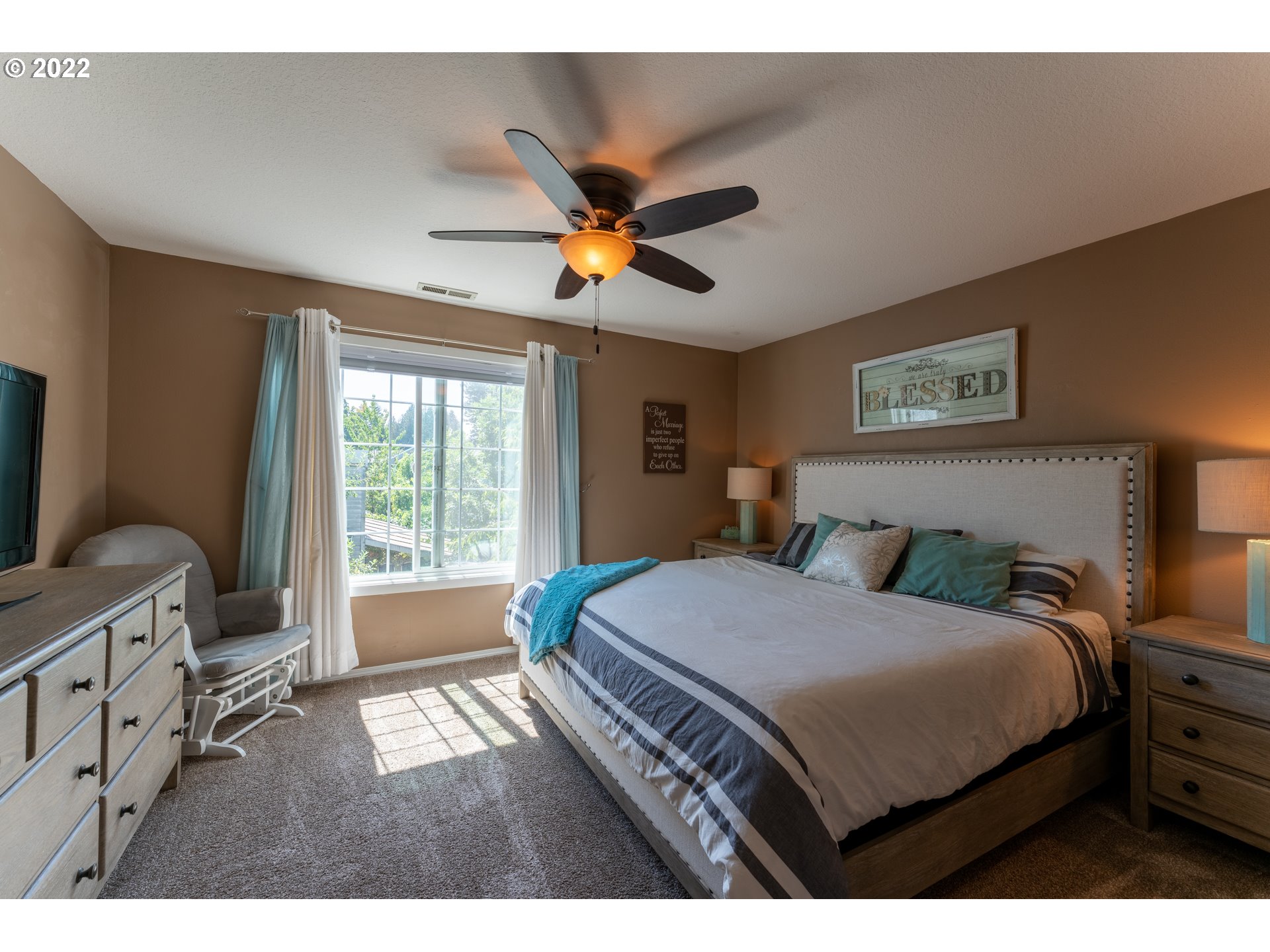 10594 Southwest Windsor Court Tigard, OR 97223 - Photo 20 of 31 a bedroom with a bed and a window