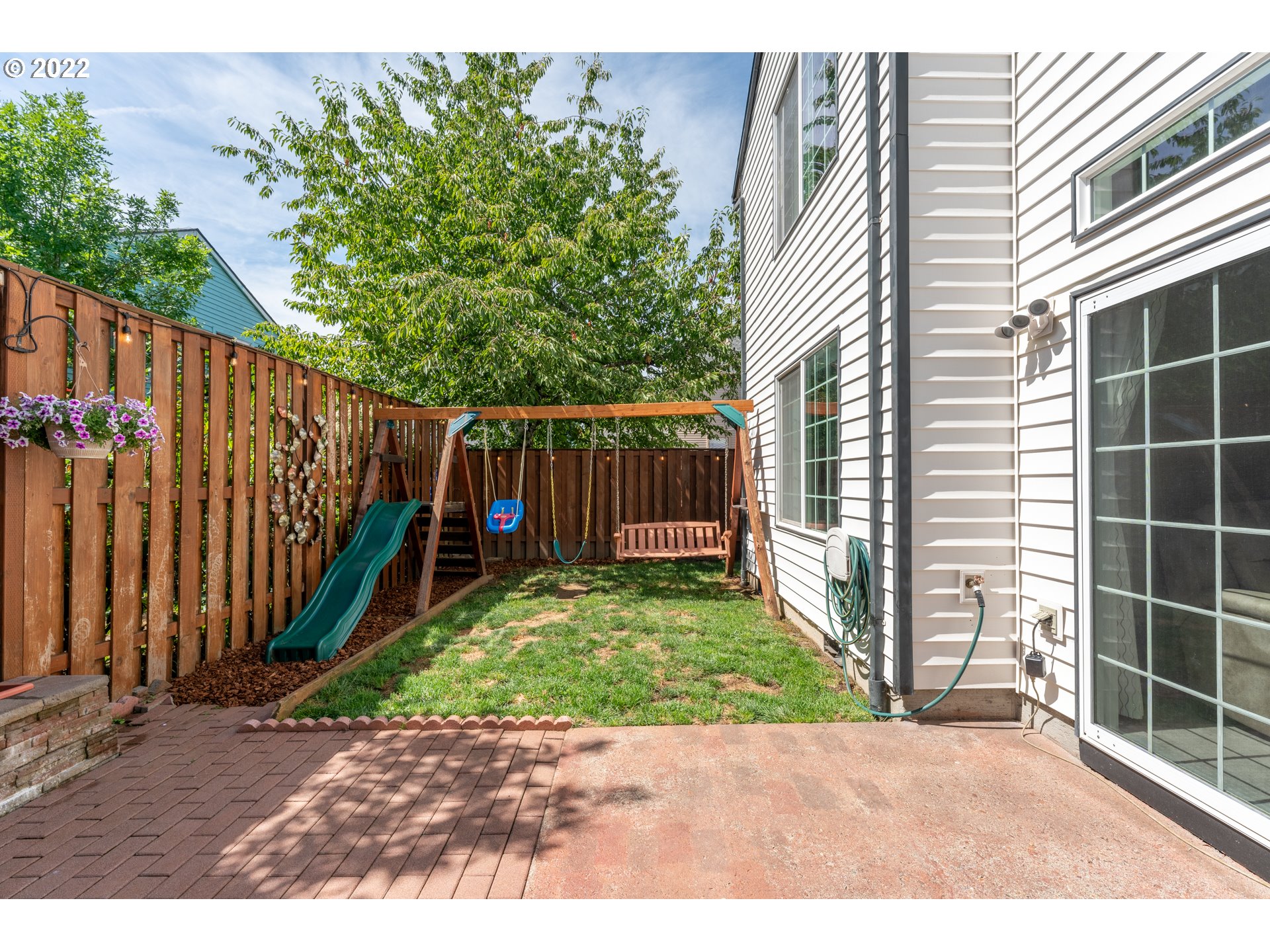 10594 Southwest Windsor Court Tigard, OR 97223 - Photo 25 of 31 a view of a backyard with a small cabin and wooden fence