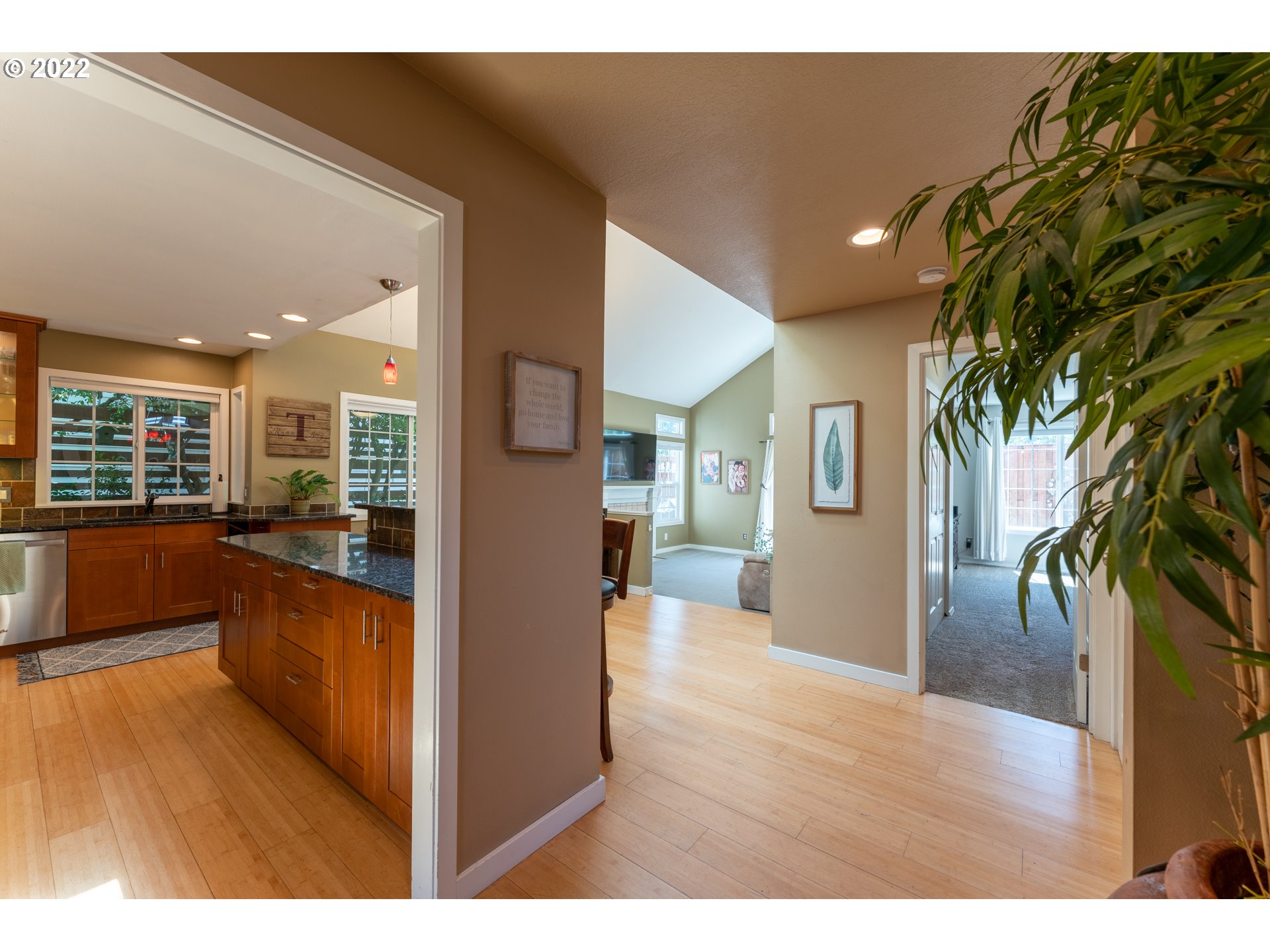 10594 Southwest Windsor Court Tigard, OR 97223 - Photo 4 of 31 a view of a living room and kitchen floor to ceiling window and wooden floor