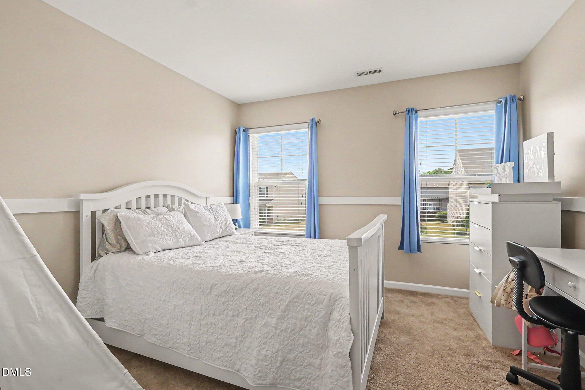 4366 Auburn Hills Drive Raleigh, NC 27616 - Photo 17 of 40 a bedroom with a bed a table and chair