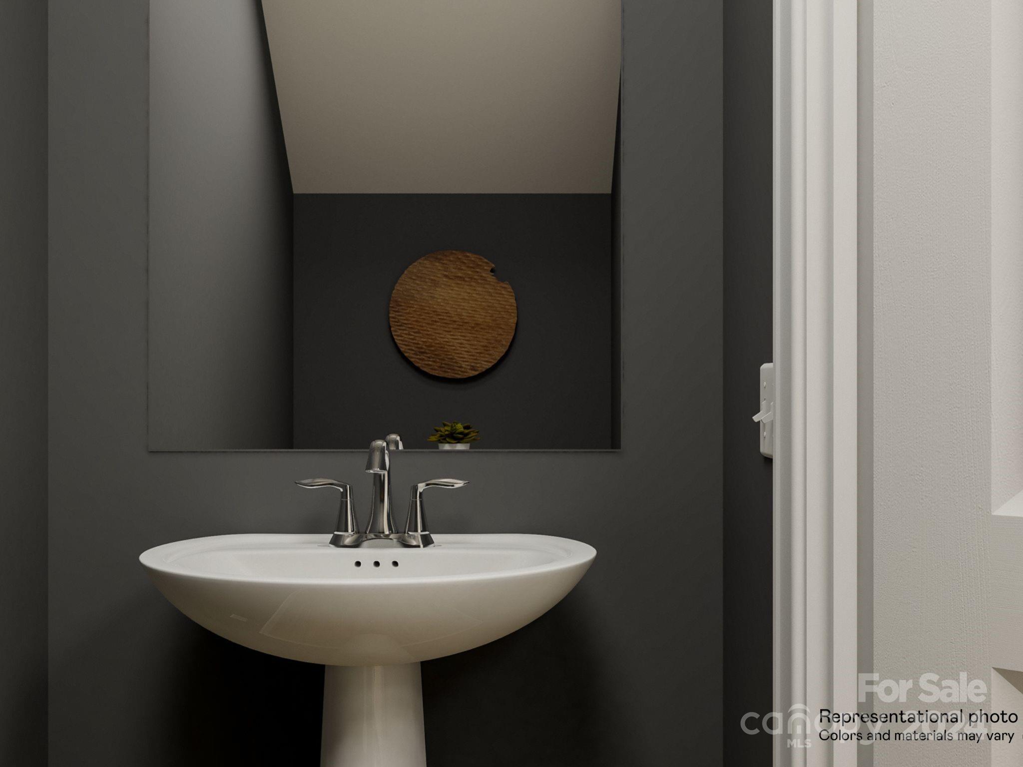 15229 Windy Plns Road Charlotte, NC 28262 - Photo 25 of 28 a bathroom with a sink and mirror