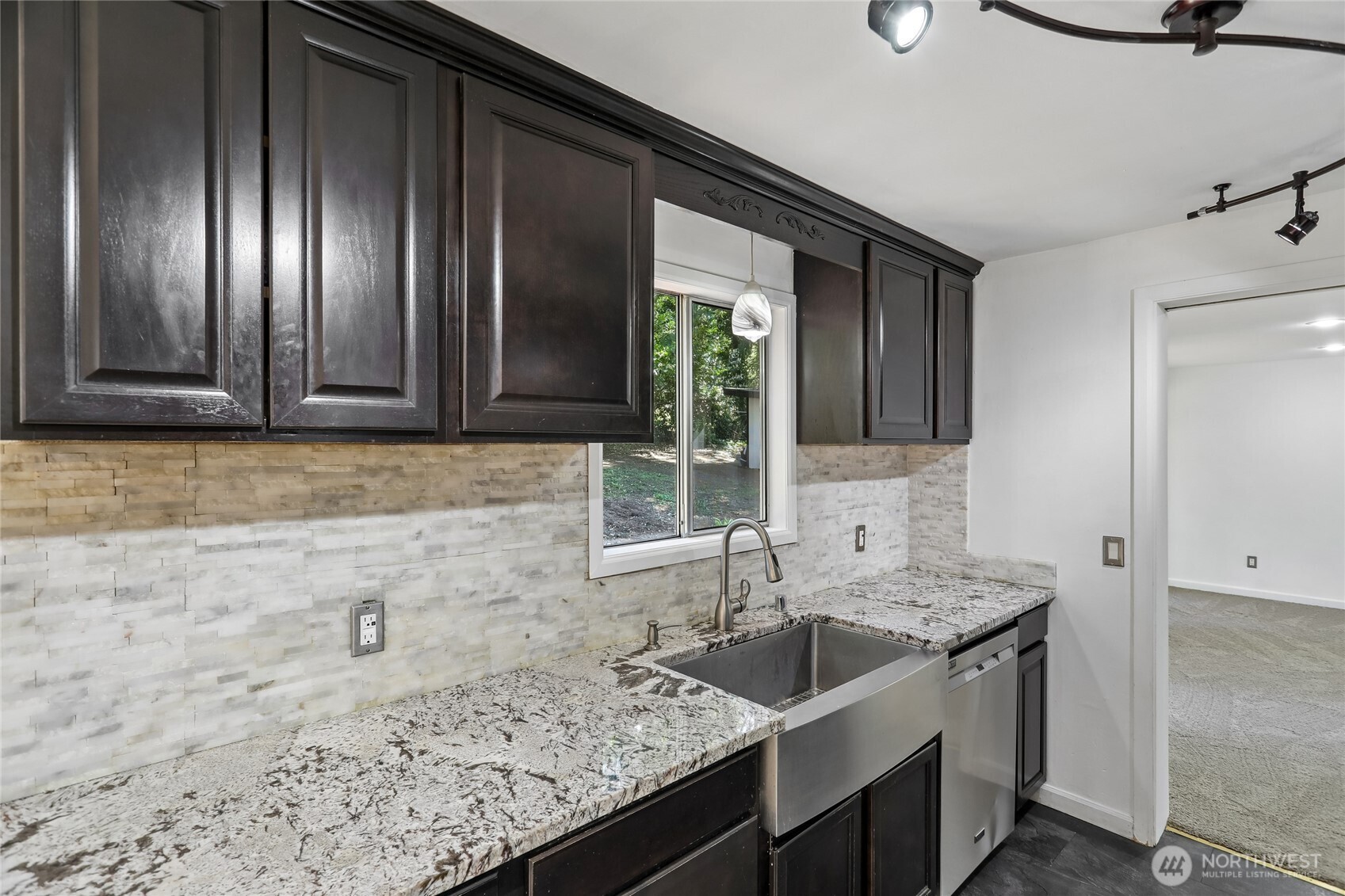 28601 Southeast 225th Street Maple Valley, WA 98038 - Photo 10 of 40 a kitchen with granite countertop stainless steel appliances a sink stove and cabinets