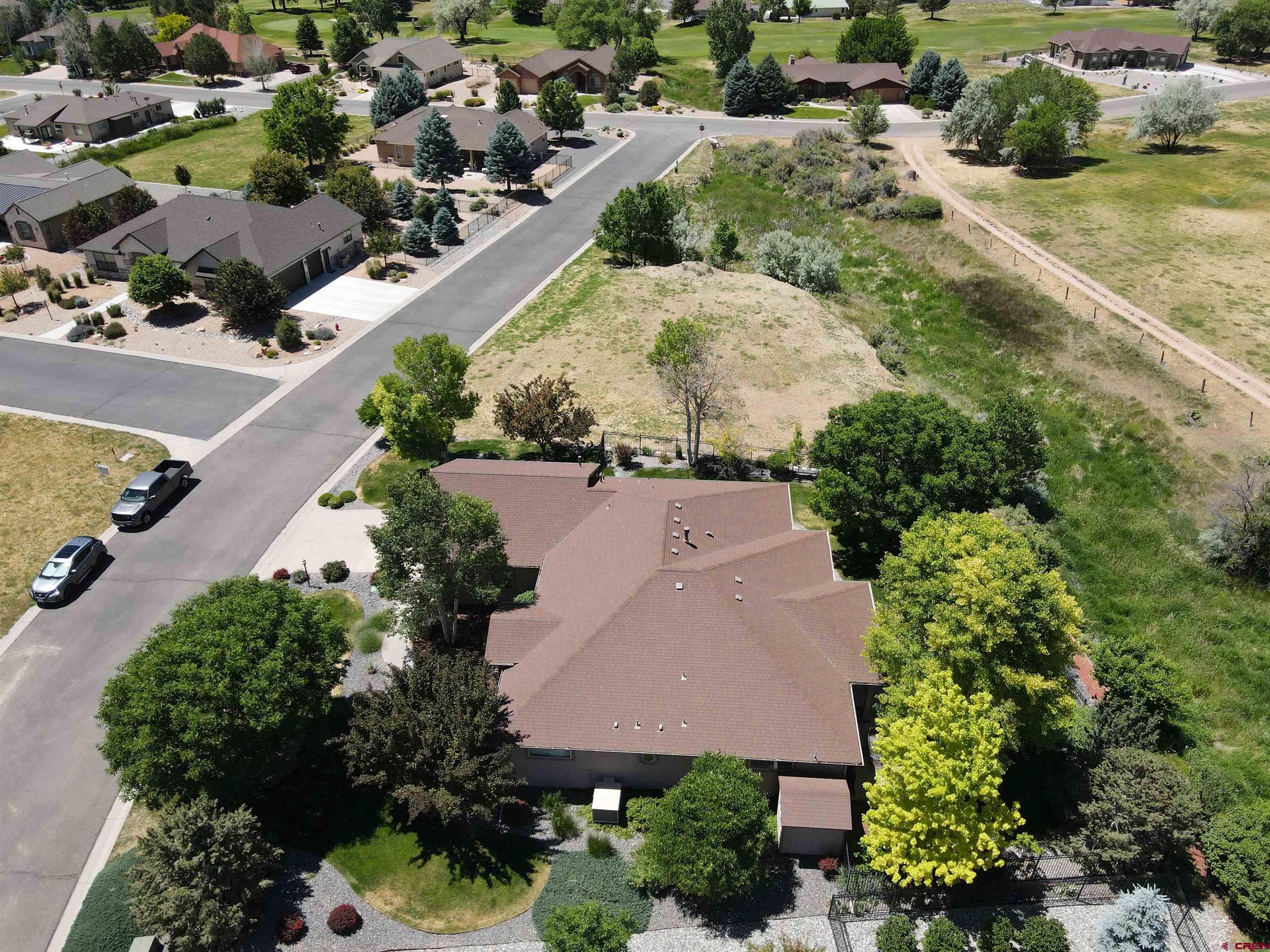 850 Southeast Pinyon Street Cedaredge, CO 81413 - Photo 41 of 45 an aerial view of a house with a yard and greenery