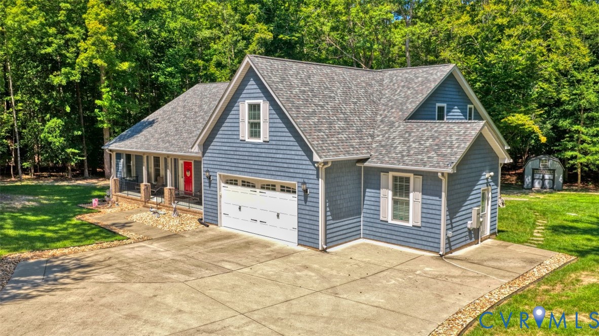 7075 Menzels Road Toano, VA 23168 - Photo 1 of 4 Blue shingle siding exterior with white trim, cove