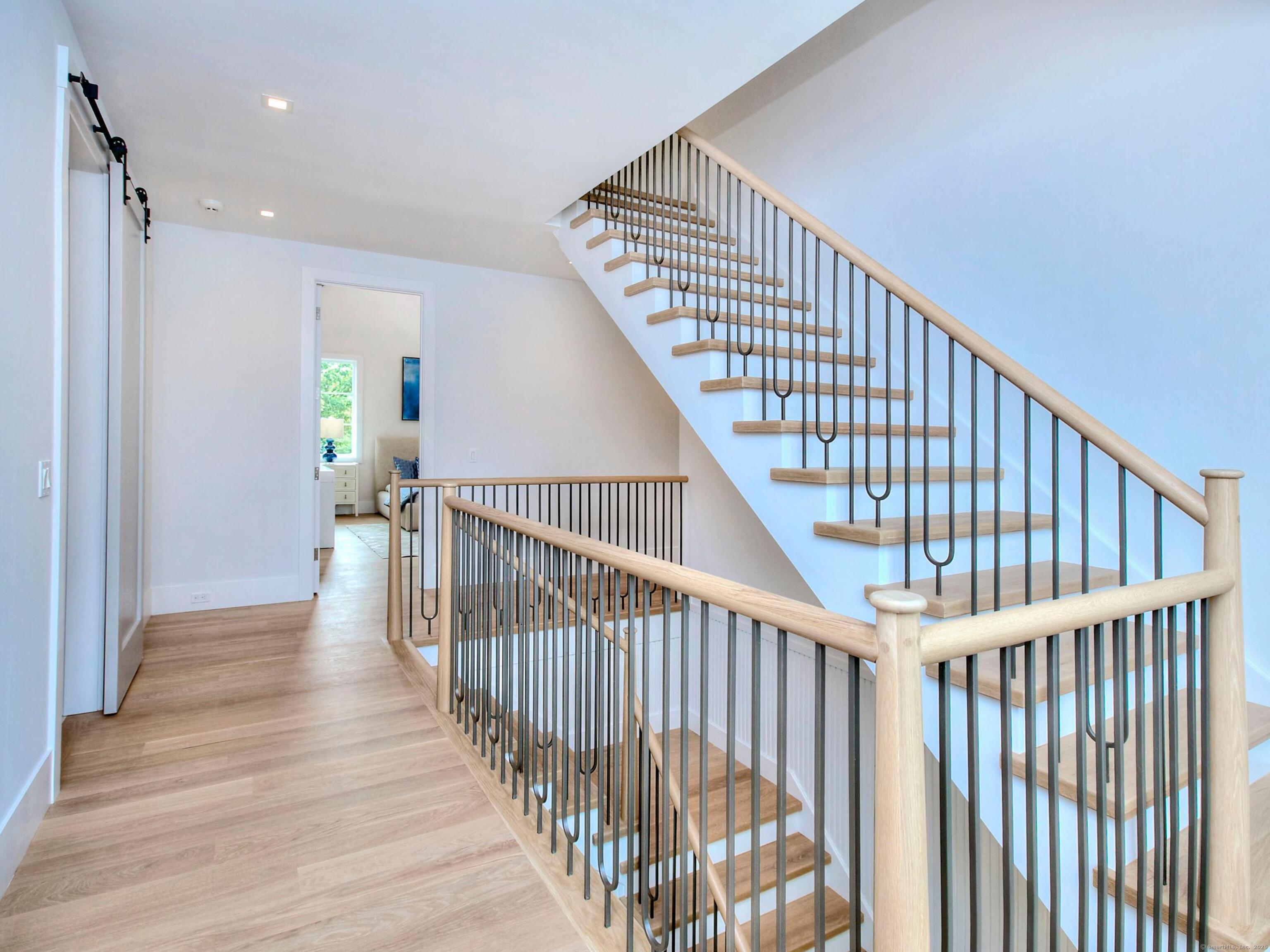 2 Webb Road Westport, CT 06880 - Photo 14 of 26 a view of staircase with wooden floor and white walls