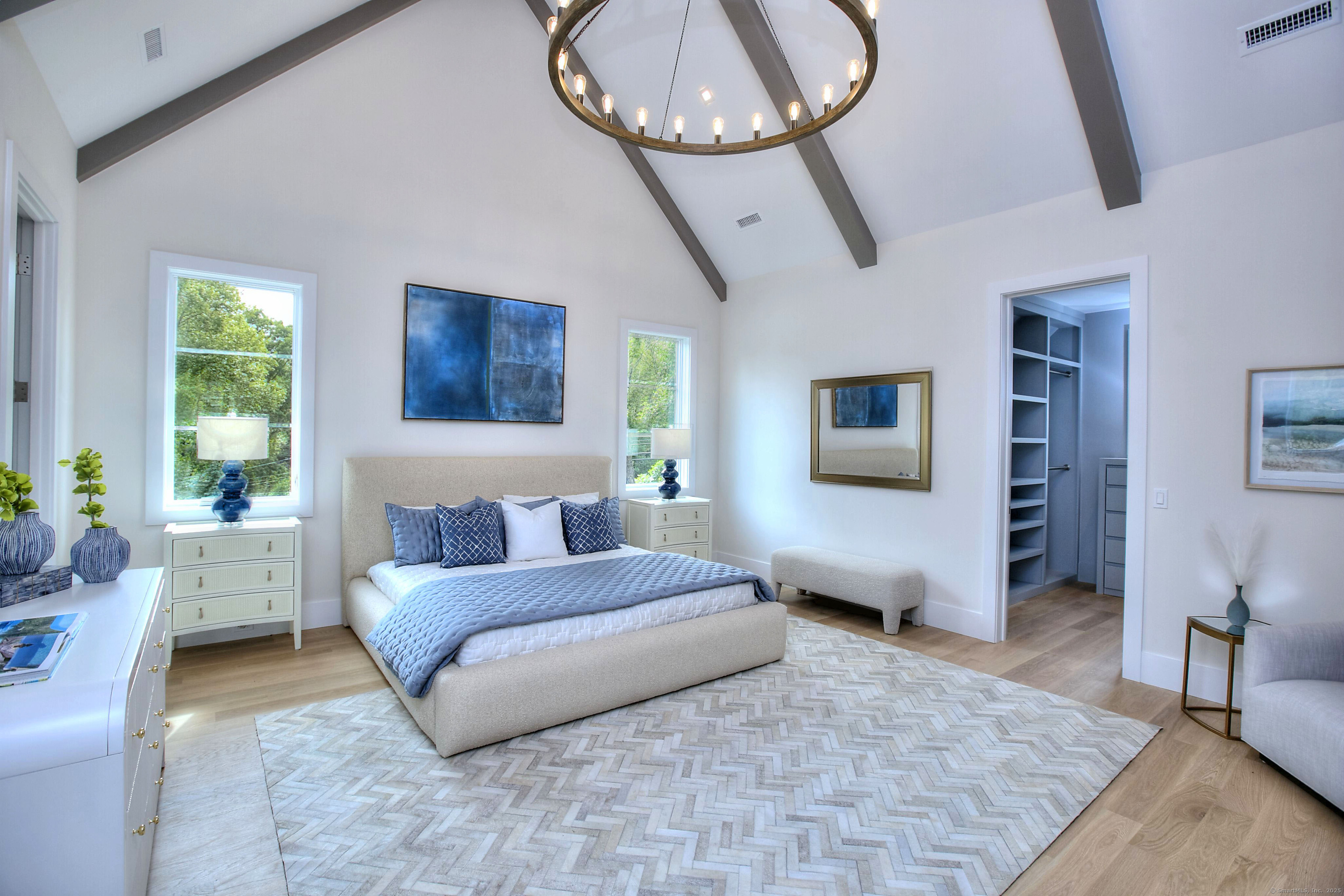 2 Webb Road Westport, CT 06880 - Photo 15 of 26 a bedroom with a large bed and a chandelier