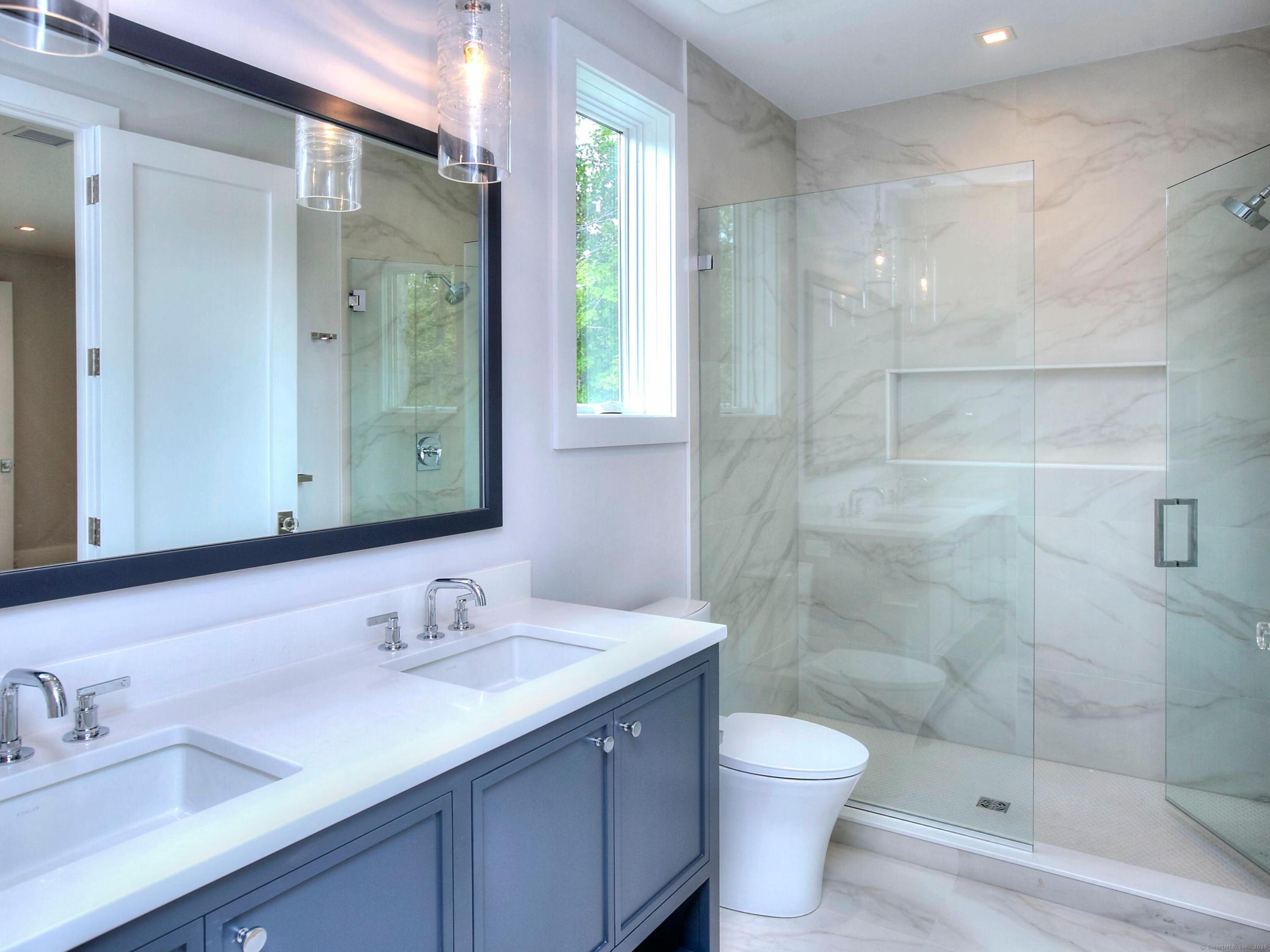 2 Webb Road Westport, CT 06880 - Photo 20 of 26 a bathroom with a double vanity sink toilet and shower