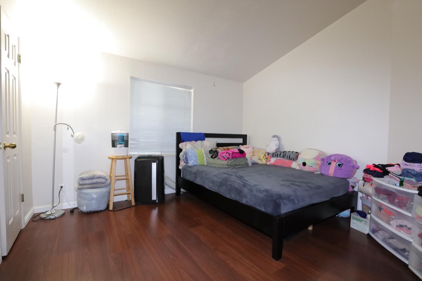 5450 Monterey Road, Unit 132 San Jose, CA 95111 - Photo 7 of 15 a bedroom with a bed and wooden floor