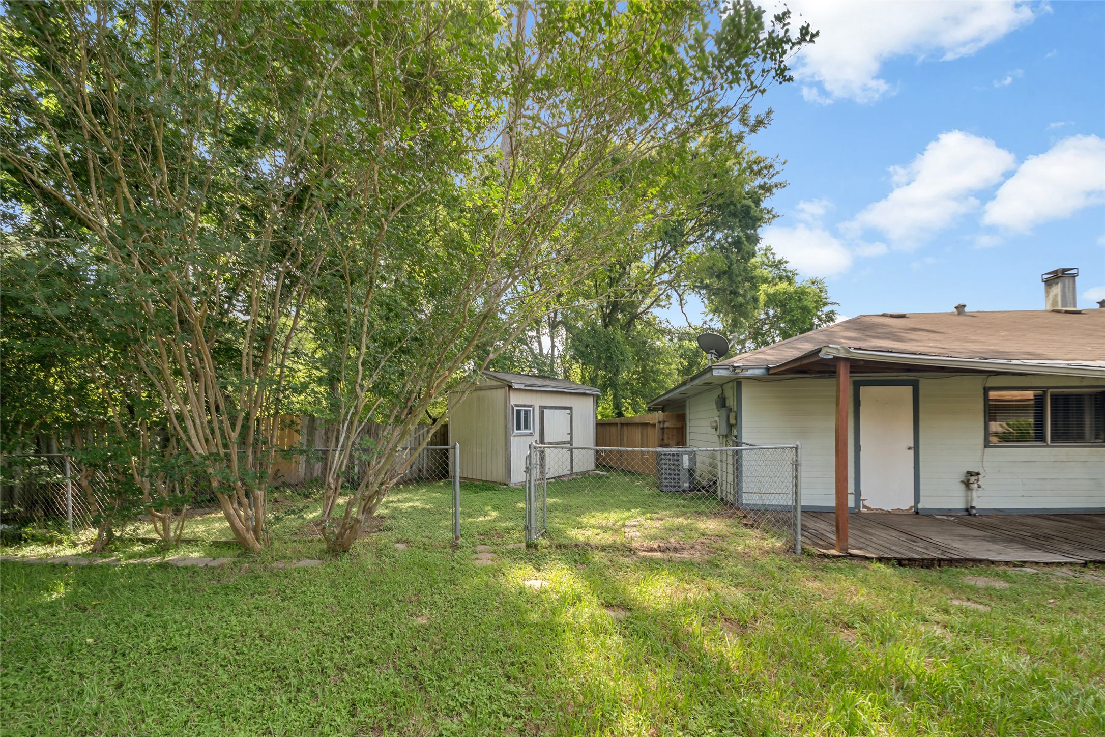 3119 Oak Rock Spring, TX 77373 - Photo 20 of 25 a view of a white house with a big yard and large trees