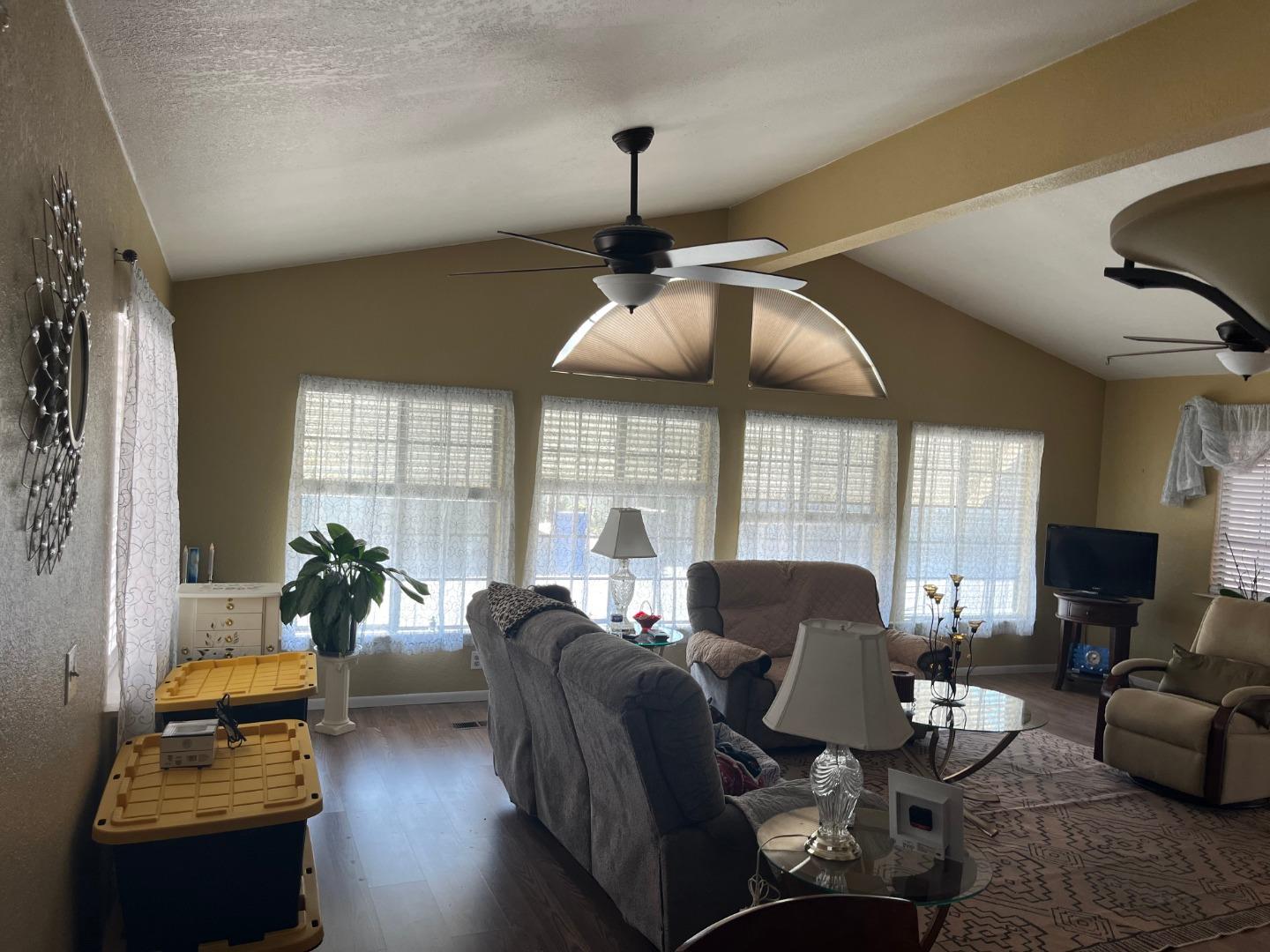 500 North Tully Road, Unit 39 Turlock, CA 95380 - Photo 13 of 32 a living room with furniture and floor to ceiling windows