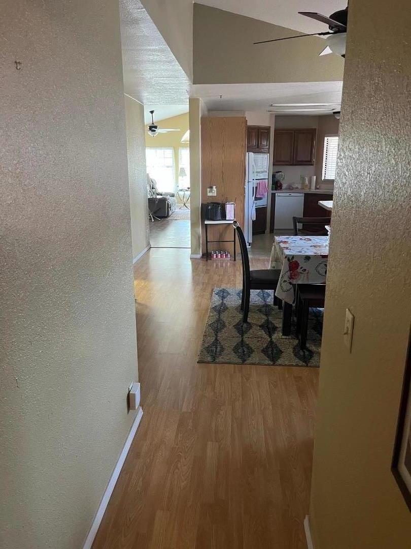 500 North Tully Road, Unit 39 Turlock, CA 95380 - Photo 15 of 32 a hallway with a dining table and chairs