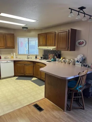 a kitchen with a sink a stove and chairs