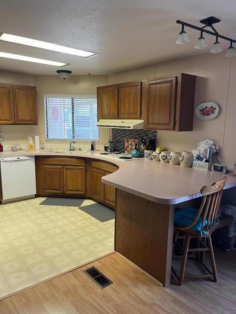 500 North Tully Road, Unit 39 Turlock, CA 95380 - Photo 6 of 32 a kitchen with a sink a stove and chairs