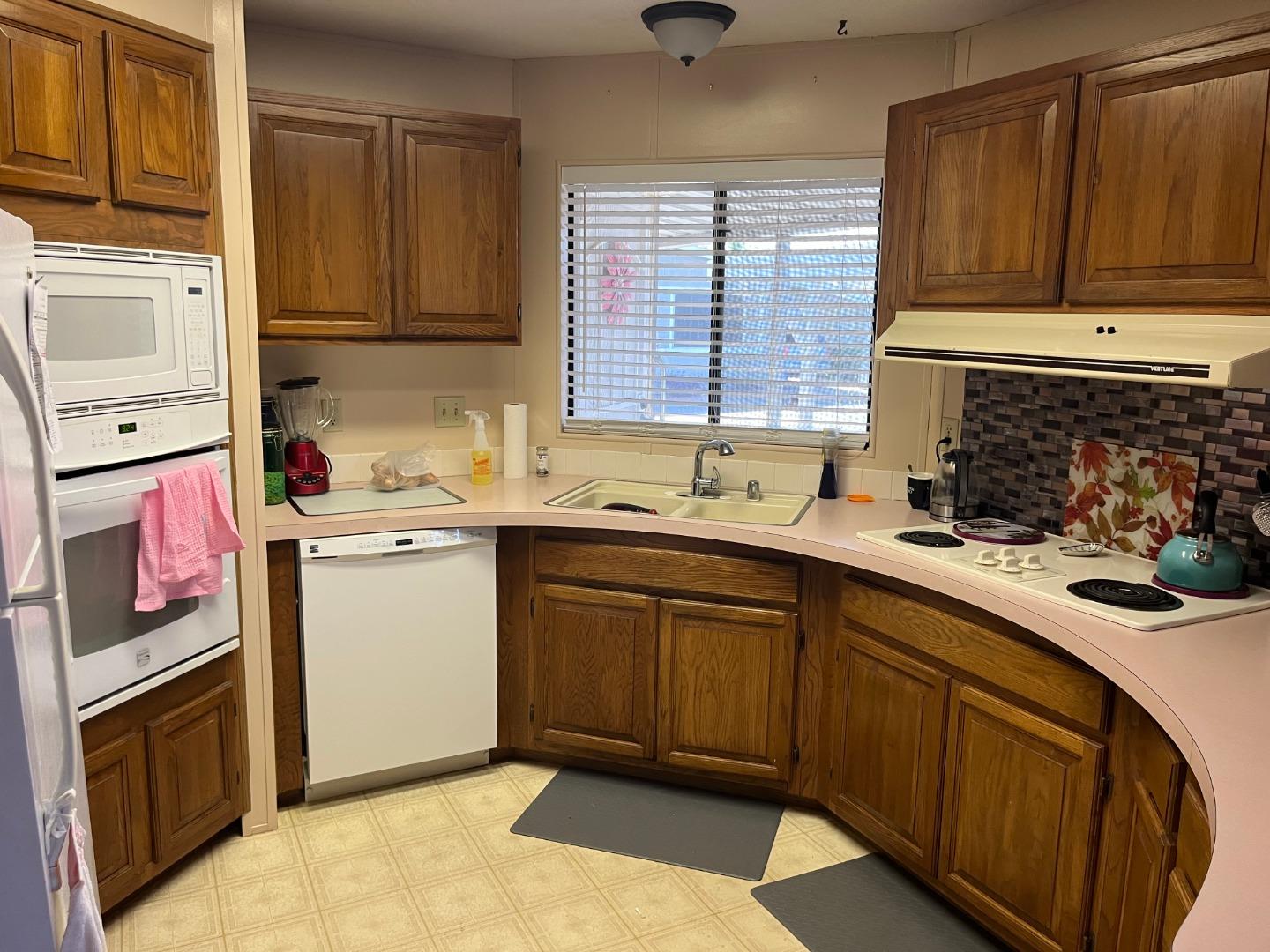 500 North Tully Road, Unit 39 Turlock, CA 95380 - Photo 7 of 32 a kitchen with a sink stove and cabinets