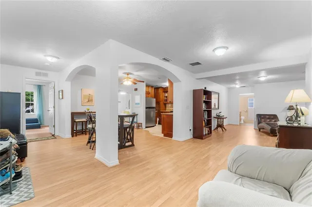a living room with furniture and a wooden floor