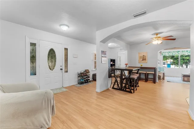 a large room with furniture and a wooden floor