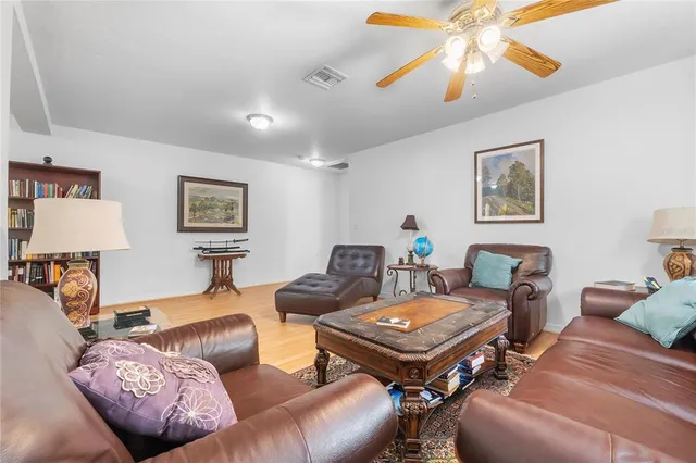 a living room with furniture and a lamp