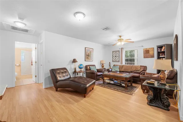 a living room with furniture and wooden floor