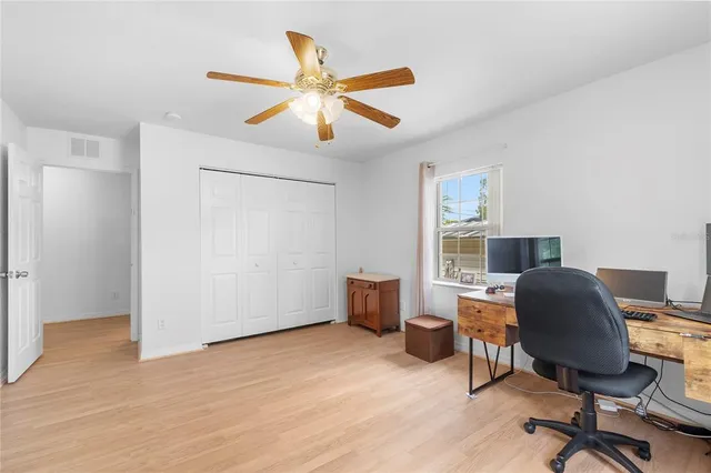 a workspace with wooden floor and a window