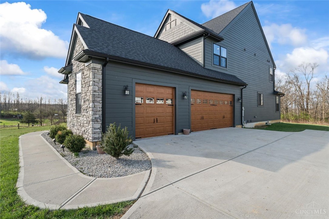 2425 Middleboro Road Clarksville, OH 45113 - Photo 20 of 91 This residence features a sophisticated exterior with a spacious concrete driveway.