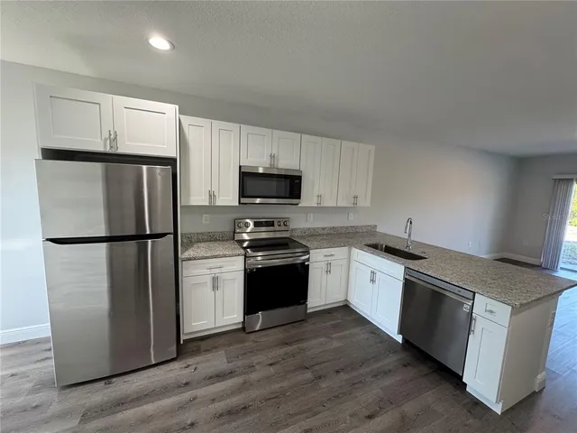 a kitchen with a refrigerator stove and microwave