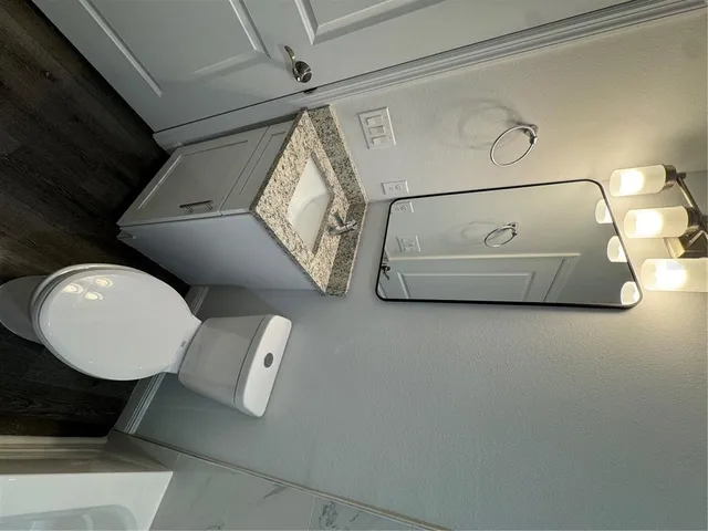 a bathroom with a bathtub and a mirror