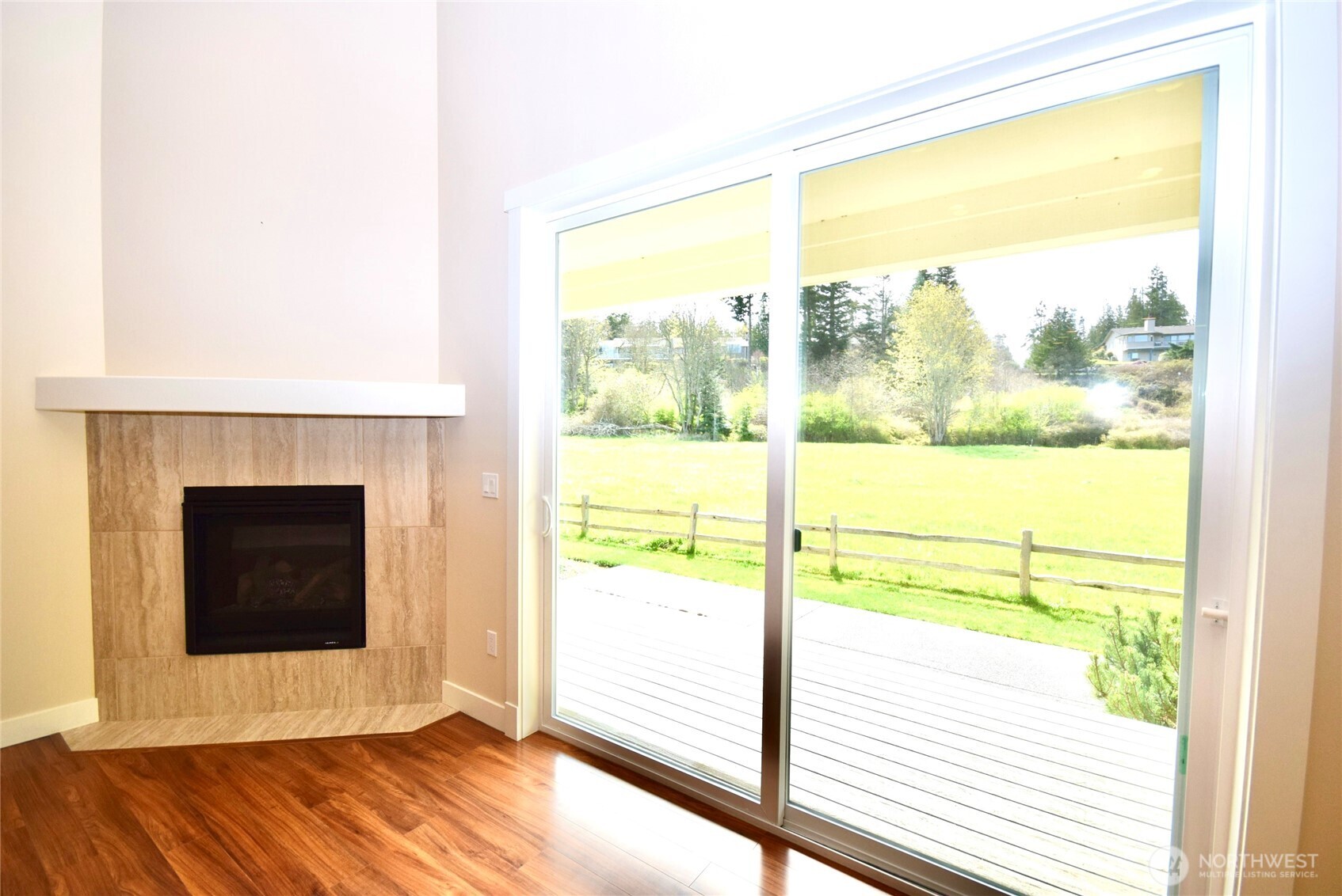 261 Mt Baker Drive, Unit B Sequim, WA 98382 - Photo 11 of 28 a view of an empty room with wooden floor and a window