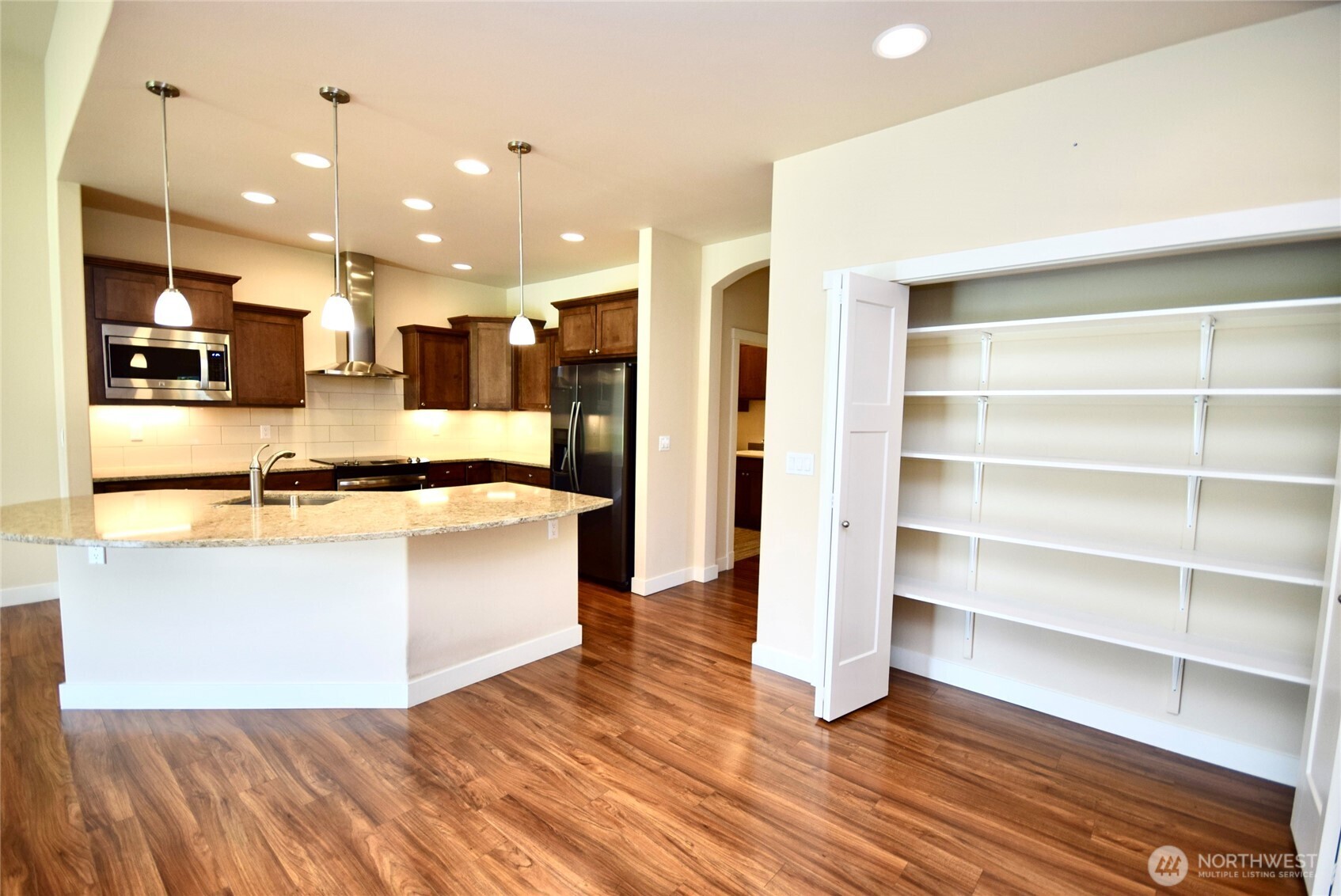 261 Mt Baker Drive, Unit B Sequim, WA 98382 - Photo 14 of 28 a large kitchen with kitchen island a sink stainless steel appliances and cabinets