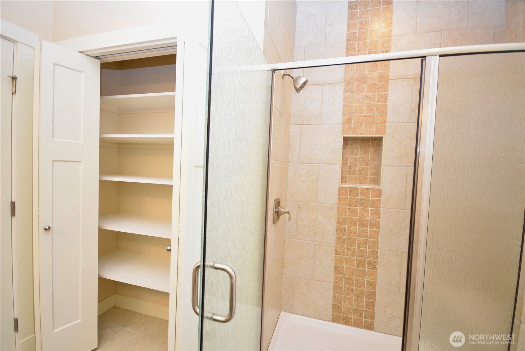261 Mt Baker Drive, Unit B Sequim, WA 98382 - Photo 19 of 28 a bathroom with a glass shower door