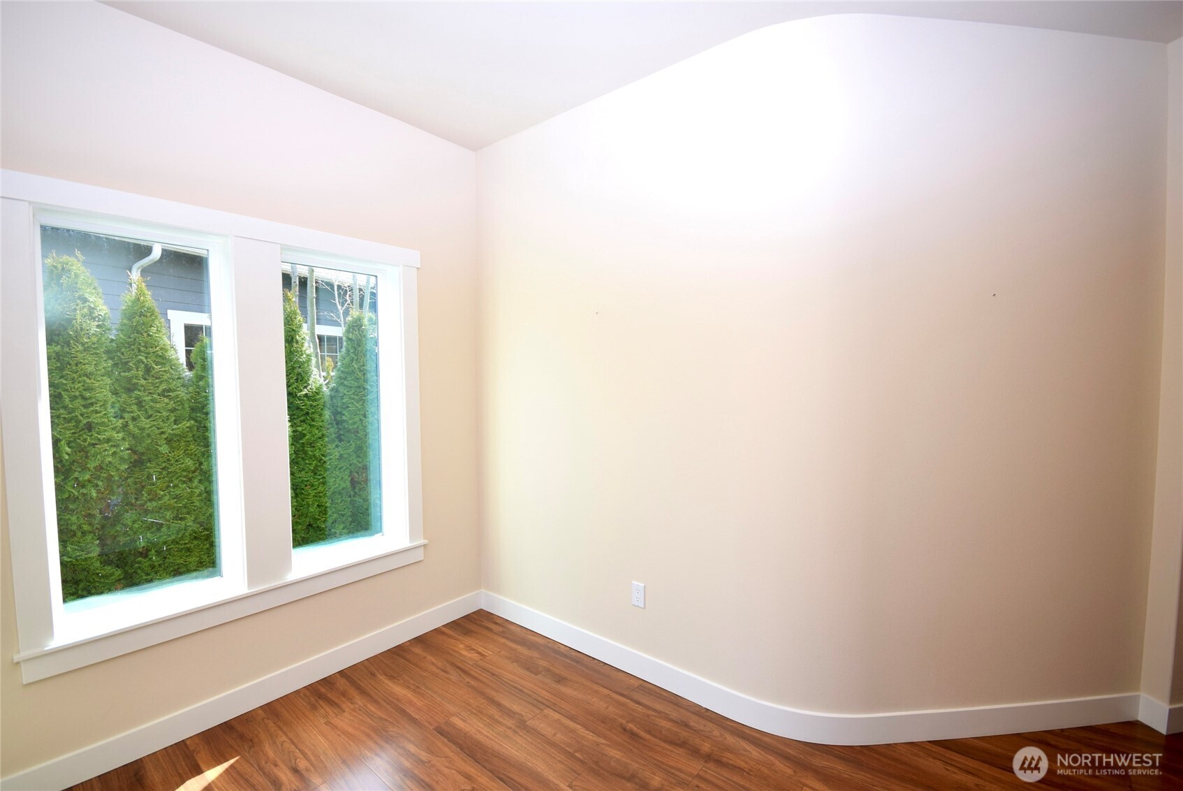 261 Mt Baker Drive, Unit B Sequim, WA 98382 - Photo 6 of 28 an empty room with wooden floor and windows