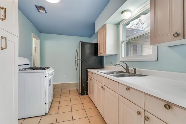 a kitchen with a sink cabinets and appliances