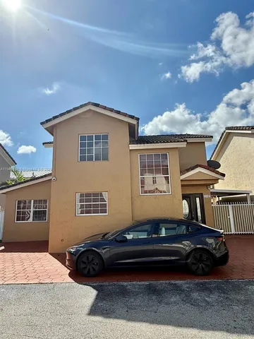 a backyard of a house with barbeque oven and outdoor seating