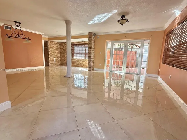 a view of an empty room with glass door