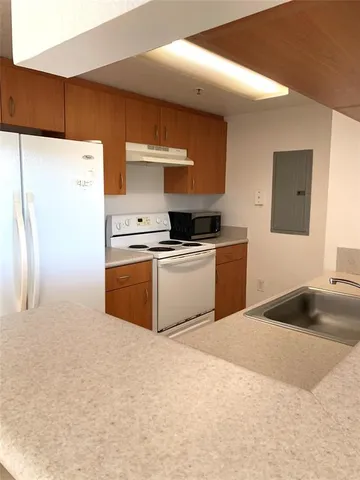 a kitchen with a sink a stove and refrigerator