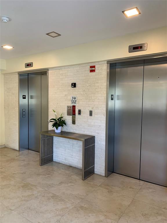 816 Northwest 11th Street, Unit 710 Miami, FL 33136 - Photo 7 of 10 a kitchen with stainless steel appliances granite countertop a refrigerator and a sink