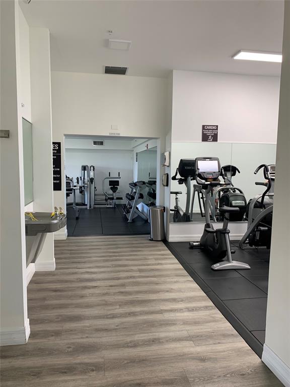 816 Northwest 11th Street, Unit 710 Miami, FL 33136 - Photo 8 of 10 a living room with furniture and a wooden floor