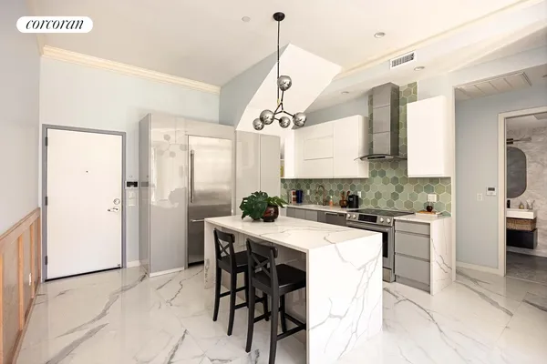 a kitchen with a table and chairs in it